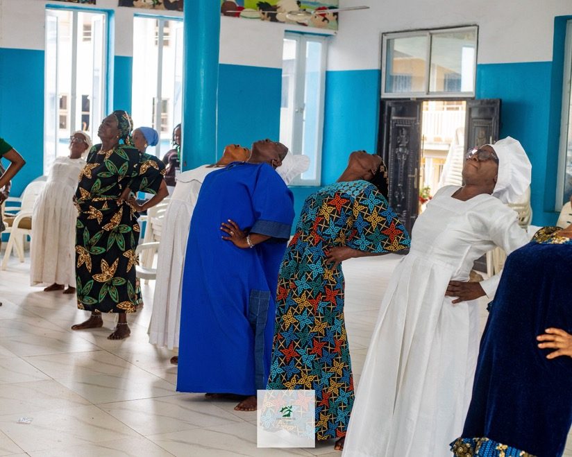 A group stretching session at the Mokola outreach